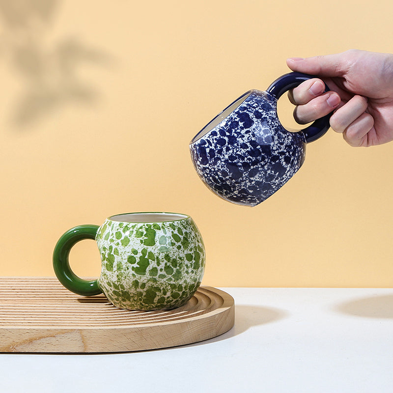 Finger-painted creative cups in various colors