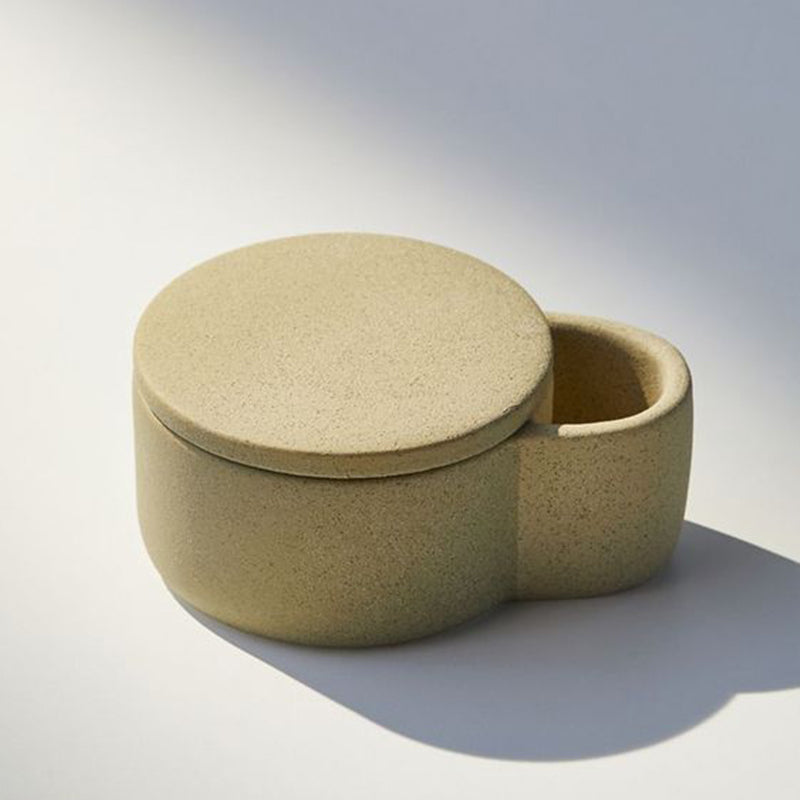 Plain stoneware candle jar with match compartment design